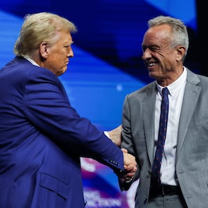 Robert F. Kennedy Jr. and Republican presidential nominee and former U.S. President Donald Trump greet each other at a campaign event sponsored by conservative group Turning Point USA, in Duluth, Georgia, U.S., October 23, 2024. REUTERS/Carlos Barria