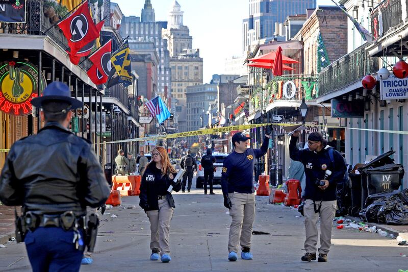 Police descend on Bourbon Street after more than a dozen people were killed when a person drove into a crowd of revelers in the early morning hours of New Year's Day.