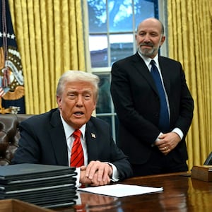 US President Donald Trump speaks to the press after signing an executive order, alongside US Secretary of Commerce nominee Howard Lutnick (R), in the Oval Office of the White House in Washington, DC, on February 10, 2025.