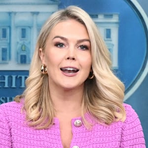 White House Press Secretary Karoline Leavitt speaks as U.S. Secretary of Treasury Scott Bessent looks on at a press conference marking the first 100 days of President Donald Trump's second term.
