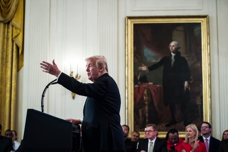President Donald J. Trump gestures as he speaks in front of a painting of George Washington during a "Pledge to Americas Workers" event in the East Room of the White House.