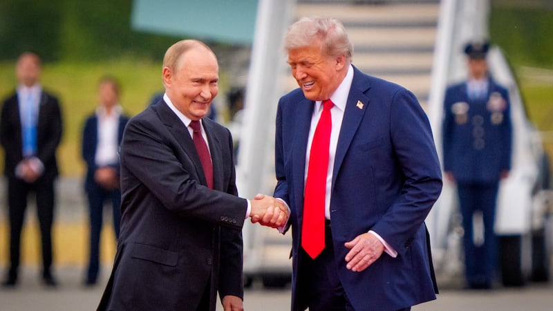 ANCHORAGE, ALASKA - AUGUST 15: (EDITOR'S NOTE: Alternate Crop) U.S. President Donald Trump (R) greets Russian President Vladimir Putin as he arrives at Joint Base Elmendorf-Richardson on August 15, 2025 in Anchorage, Alaska. The two leaders are meeting for peace talks aimed at ending the war in Ukraine. (Photo by Andrew Harnik/Getty Images)
