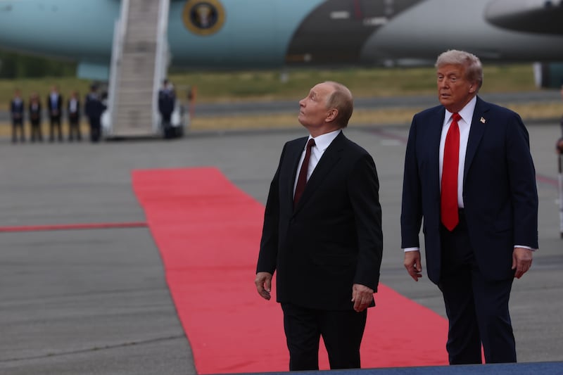 President Donald Trump and Russian President Vladimir Putin look up to observe a flyover as they meet for their summit on the war in Ukraine in Anchorage, Alaska on August 15.