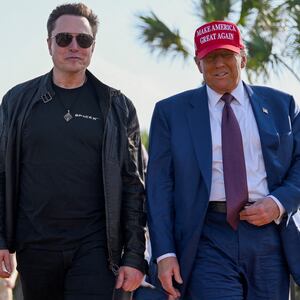 U.S. President-elect Donald Trump walks with Elon Musk.