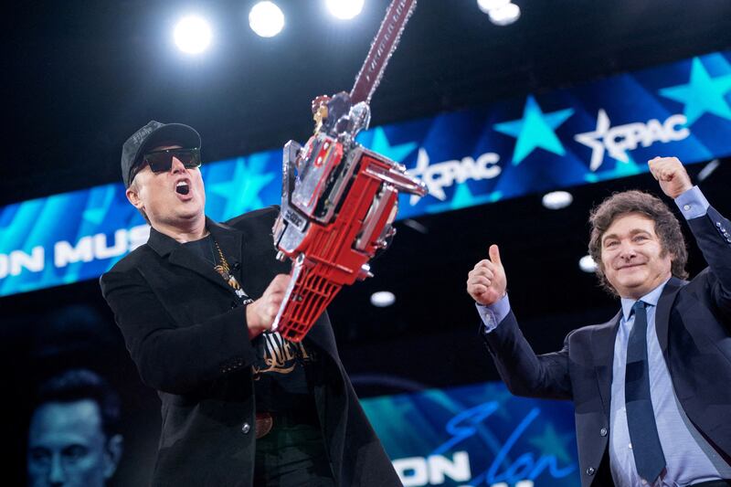 FILE PHOTO: Elon Musk displays a chainsaw given to him by President of Argentina Javier Milei during the Conservative Political Action Conference (CPAC) in National Harbor, Maryland, U.S., February 20, 2025. REUTERS/Nathan Howard     TPX IMAGES OF THE DAY/File Photo