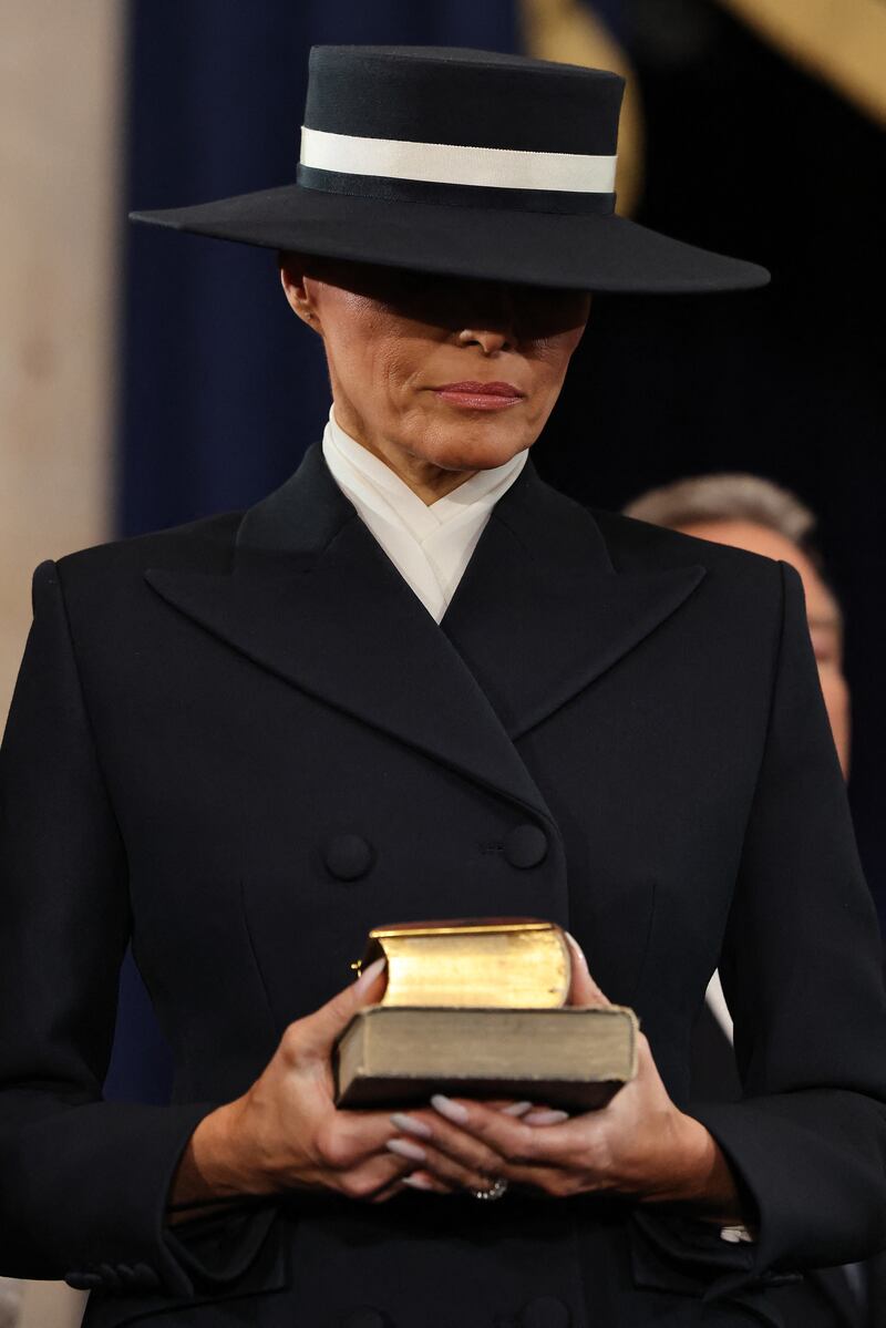 US First lady Melania Trump holds two Bibles during inauguration ceremonies in the Rotunda of the U.S. Capitol on January 20, 2025 in Washington, DC.