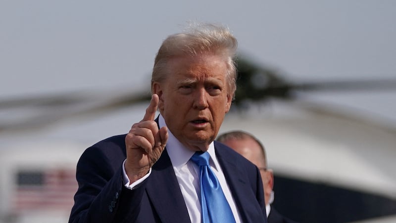 U.S. President Donald Trump gestures as he walks to board Air Force One as he departs for Rome, Italy, to attend Pope Francis' funeral.