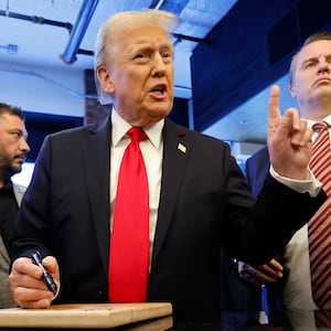 Donald Trump signs autographs in November.