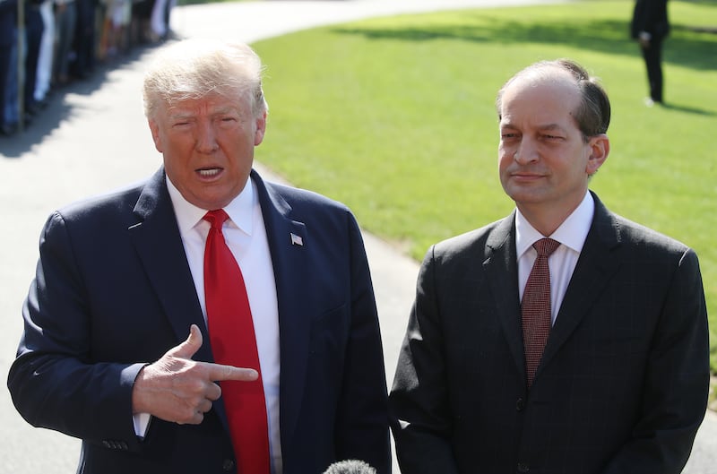 President Donald Trump stands with Labor Secretary Alex Acosta.