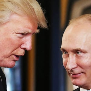 US President Donald Trump (L) chats with Russia's President Vladimir Putin as they attend the APEC Economic Leaders' Meeting, part of the Asia-Pacific Economic Cooperation (APEC) leaders' summit in the central Vietnamese city of Danang on November 11, 2017.