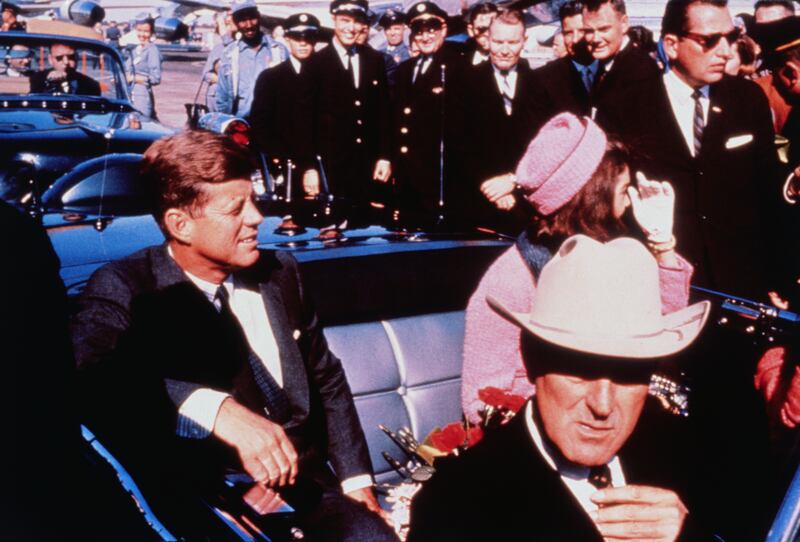 US President John F Kennedy, First Lady Jacqueline Kennedy, Texas Governor John Connally, and others smile at the crowds lining their motorcade route in Dallas, Texas, on November 22, 1963. Minutes later the President was assassinated as his car passed through Dealey Plaza.