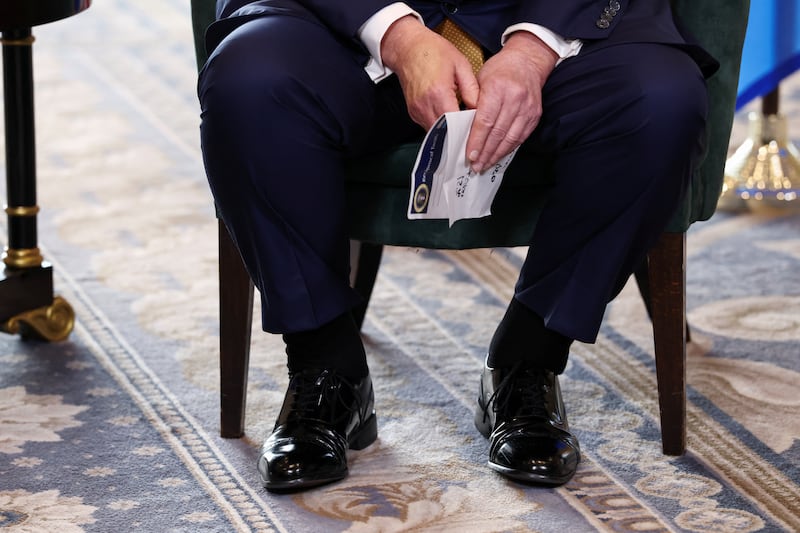 Make-up covers the back of the right hand of U.S. President Donald Trump, as he meets with European Commission President Ursula von der Leyen (not pictured), after the announcement of a trade deal between the U.S. and EU, in Turnberry, Scotland, Britain, July 27, 2025. REUTERS/Evelyn Hockstein