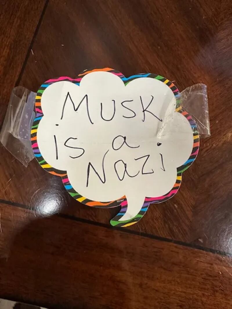 A "Musk is a Nazi" sign found taped to writier and political columnist Chris Cillizza's Tesla car.
