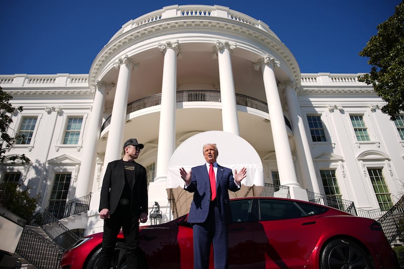 WASHINGTON, DC - MARCH 11: U.S. President Donald Trump and White House Senior Advisor, Tesla and SpaceX CEO Elon Musk deliver remarks next to a Tesla Model S on the South Lawn of the White House on March 11, 2025 in Washington, DC. Trump spoke out against calls for a boycott of Elon Musk’s companies and said he would purchase a Tesla vehicle in what he calls a ‘show of confidence and support’ for Elon Musk.