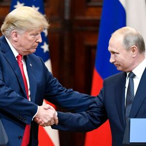 President Donald Trump (L) shakes hands with Russian President Vladimir Putin during a joint press conference in Helsinki, Finland, on July 16, 2018.