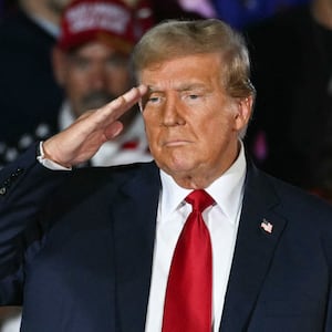 Donald Trump does a military salute during a campaign rally as he celebrates his 78th birthday at West Palm Convention Center, in West Palm Beach, Florida, on June 14, 2024.