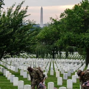 ARLINGTON, VIRGINIA - MAY 23: Members of the 3rd U.S. Infantry Regiment, also known as the "Old Guard," place flags at the headstones of U.S. military personnel buried at Arlington National Cemetery ahead of Memorial Day, on May 23, 2024 in Arlington, Virginia.