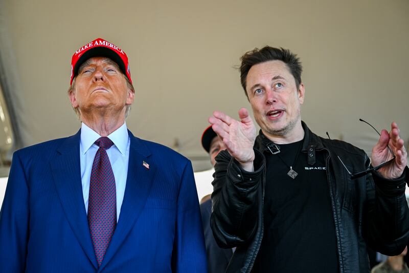 BROWNSVILLE, TEXAS - NOVEMBER 19: Elon Musk speaks with U.S. President-elect Donald Trump as they watch the launch of the sixth test flight of the SpaceX Starship rocket on November 19, 2024 in Brownsville, Texas.
