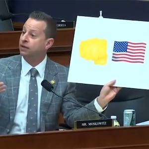 Congressman Jared Moskowitz holding a sign from Trump admin's Signal chat.