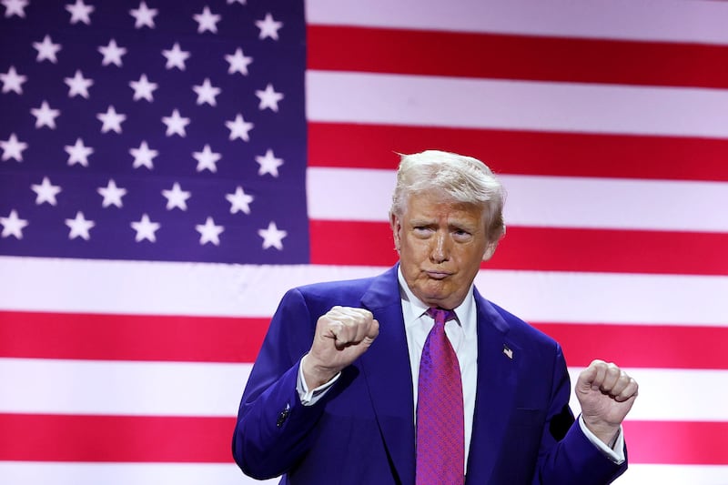 President Donald J. Trump gestures on stage as he tours the Al Udeid Air Base on May 15, 2025, in Doha, Qatar.