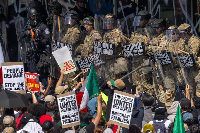 LOS ANGELES, CALIFORNIA - JUNE 09: A police officer holds a nonlethal rifle as protesters confront California National Guard soldiers and police outside of a federal building as protests continue in Los Angeles following three days of clashes with police after a series of immigration raids on June 09, 2025 in Los Angeles, California. Tensions in the city remain high after the Trump administration called in the National Guard against the wishes of city leaders.  (Photo by David McNew/Getty Images)