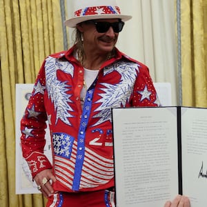 U.S. President Donald Trump holds an executive order related to the U.S. live entertainment ticketing industry, next to Kid Rock, in the Oval Office at the White House in Washington, D.C., March 31, 2025.   REUTERS/Leah Millis     TPX IMAGES OF THE DAY