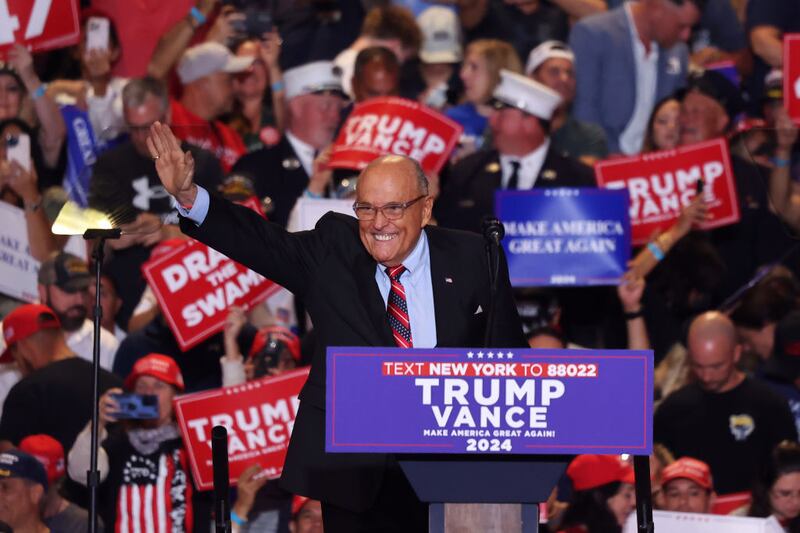 Former New York City Mayor Rudy Giuliani takes the stage at a campaign rally for Donald Trump.