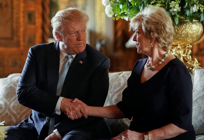 U.S. President Donald Trump shakes hands with Linda McMahon, the outgoing Administrator of the Small Business Administration, as she sits beside him after announcing her resignation, at Trump's Mar-a-Lago estate in Palm Beach, Florida, U.S., March 29, 2019. REUTERS/Joshua Roberts
