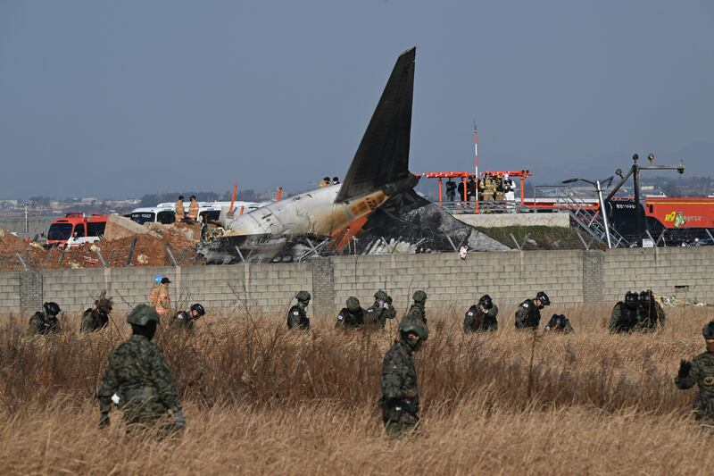 South Korean soldiers search for missing passengers near wreckage of the crashed Jeju Air Boeing 737-800.