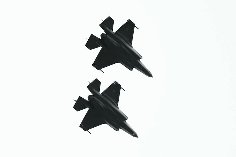 Two F-22 fighter jets fly over as a plane carrying Russian President Vladimir Putin (not picture) arrives at Joint Base Elmendorf-Richardson in Anchorage, Alaska, on August 15, 2025.