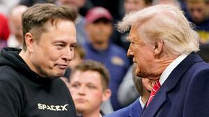 FILE PHOTO: Tesla CEO Elon Musk greets U.S. President Donald Trump as they attend the NCAA men's wrestling championships in Philadelphia, Pennsylvania, U.S., March 22, 2025. REUTERS/Nathan Howard/File Photo