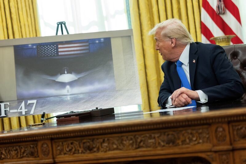 Donald Trump speaks next to an image of an F-47 sixth-generation fighter jet in the Oval Office on Friday.
