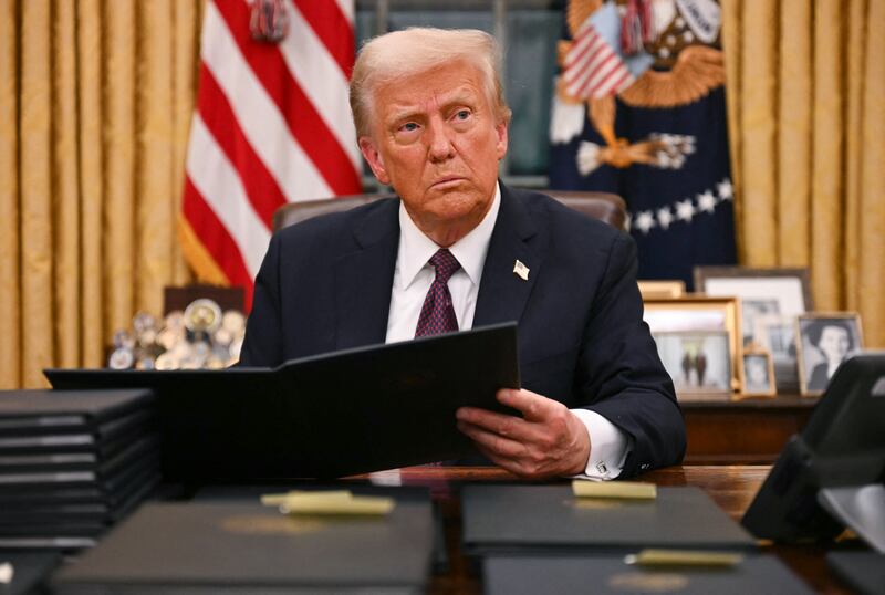 US President Donald Trump signs an executive order for pardons on January 6 offenders in the Oval Office of the WHite House in Washington, DC, on January 20, 2025.