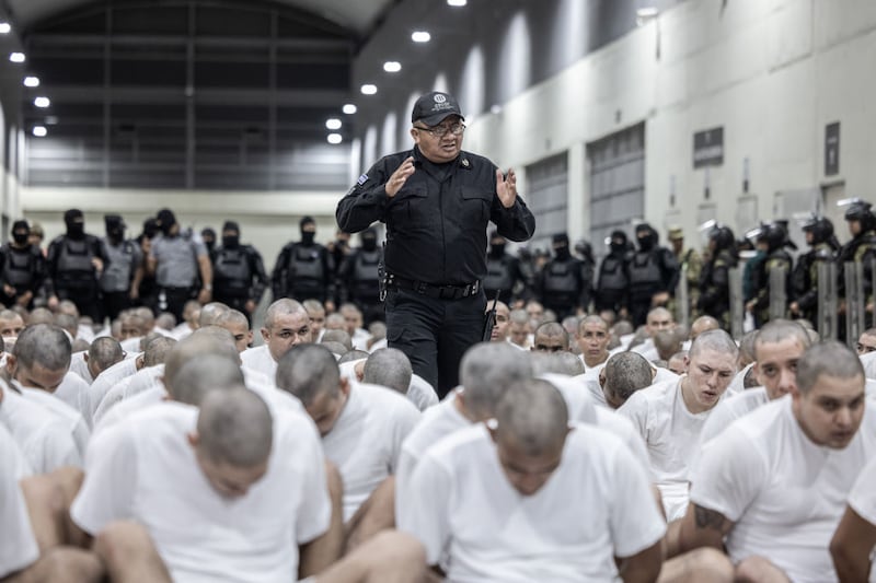 The 250 men deported by the Trump administration for their alleged gang ties arrive in El Salvador.