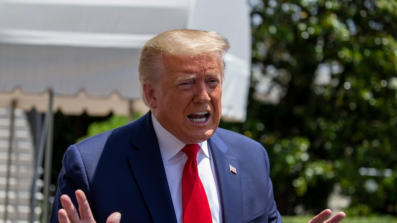 WASHINGTON, DC - MAY 30: U.S. President Donald Trump talks to the media outside the White House as he heads to the SpaceX launch in Florida on May 30, 2020 in Washington, DC. President Donald Trump warned that protesters outside the White House Friday night could have been "greeted" with "vicious dogs" and "ominous weapons" if they had breached the fence, and praised the Secret Service for their response to the demonstrations. (Photo by Tasos Katopodis/Getty Images)