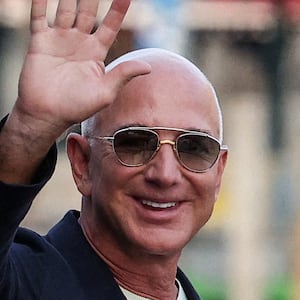 Jeff Bezos gestures as he leaves Aman Venice hotel ahead of this wedding.