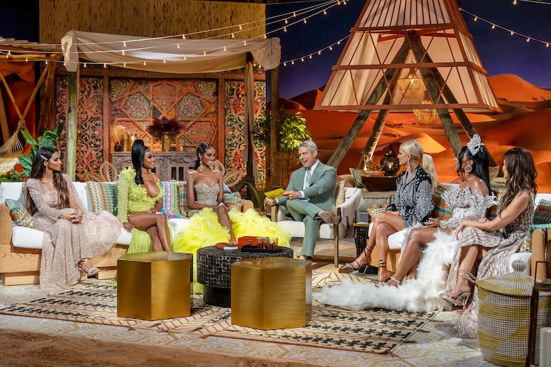 Photo still of Sara Al Medani, Lesa Milan, Chanel Ayan, Andy Cohen, Caroline Stanbury, Caroline Brooks, and Nina Ali at the Real Housewives of Dubai reunion.