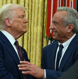 The new US Secretary of Health and Human Services Robert F. Kennedy Jr., shakes hands with US President Donald Trump after a swearing in ceremony in the Oval Office of the White House in Washington, DC, on February 13, 2025. (Photo by ANDREW CABALLERO-REYNOLDS / AFP)