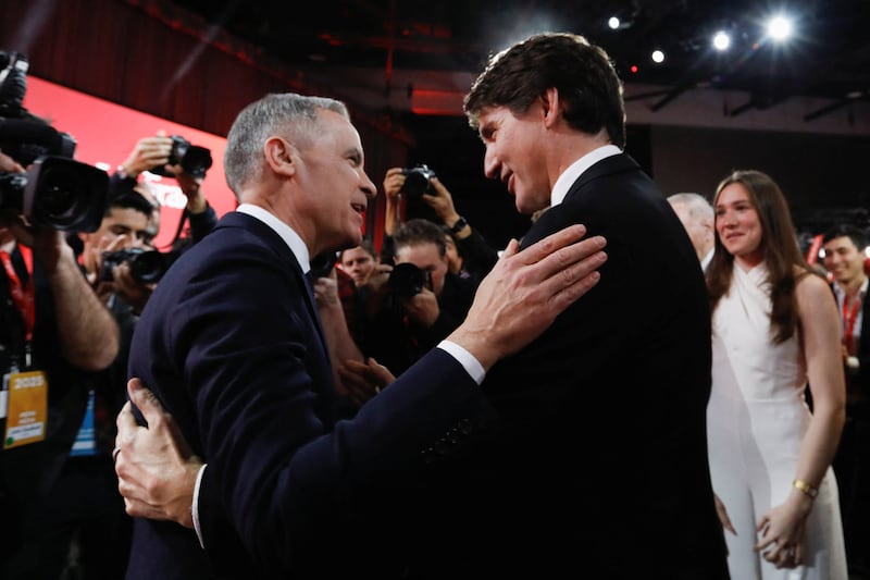 Former Bank of Canada and Bank of England governor Mark Carney and  Justin Trudeau embrace after Carney won the race to become leader of Canada's ruling Liberal Party and will succeed Justin Trudeau as Prime Minister, in Ottawa, Ontario, Canada, March 9, 2025.  REUTERS/Amber Bracken/Pool     TPX IMAGES OF THE DAY