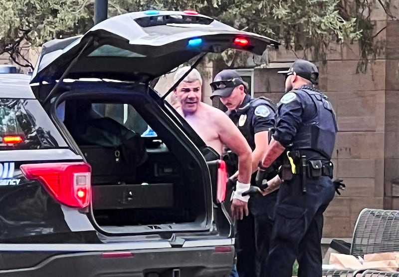 Law enforcement officers detain a suspect, after an attack that injured multiple people, in Boulder, Colorado,.