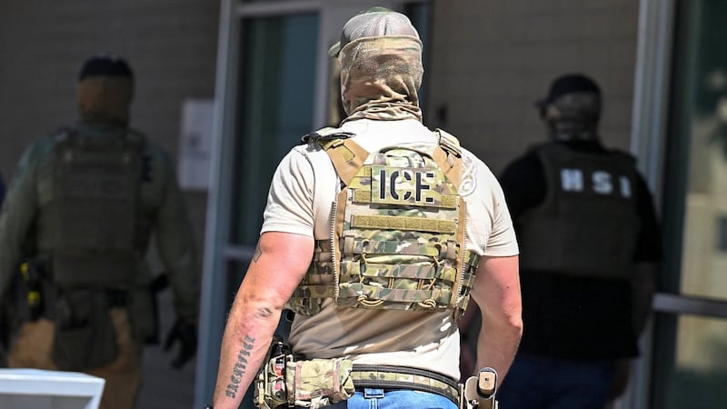 Masked law enforcement officers, including HSI and ICE agents, walk into an immigration court in Phoenix, Arizona, U.S., May 21, 2025.