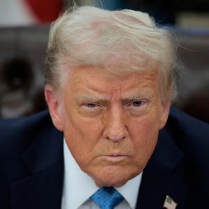 Donald Trump talks to reporters after signing an executive order.