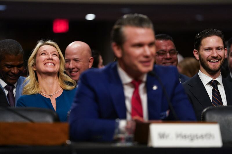 Jennifer Rauchet and Phil Hegseth smile as Pete Hegseth testifies during his confirmation hearing.
