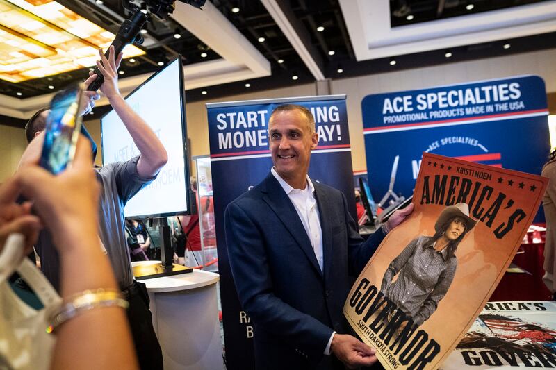 Corey Lewandowski holds a poster for  Kristi Noem during the Conservative Political Action Conference in 2021.