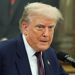 U.S. President Donald Trump speaks, as he and Apple CEO Tim Cook (not pictured) present Apple's announcement of a $100 billion investment in U.S. manufacturing, in the Oval Office at the White House in Washington, D.C., U.S., August 6, 2025. REUTERS/Jonathan Ernst