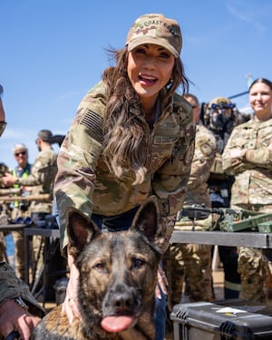 Department of Homeland Security Secretary Kristi Noem poses with a Maritime Security Response Team West K-9 in San Diego, Calif., March 16, 2025. Noem visited Coast Guard Cutter Elm (WLB-204) to be a part of a MSRT-W training operation during a visit to the southwest border.