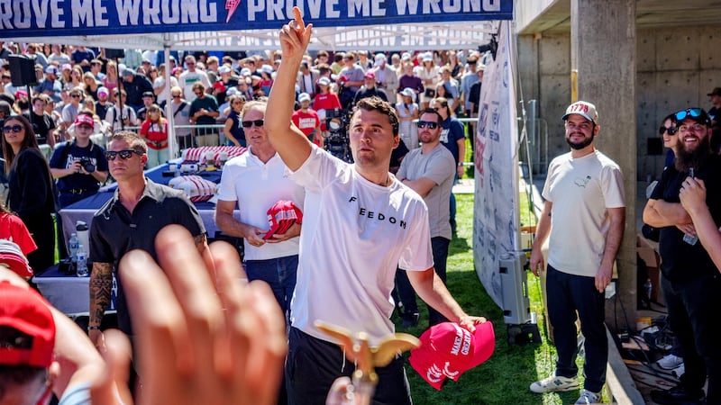 Right-wing activist and commentator Charlie Kirk throws hats to the crowd shortly before he was shot at a Utah Valley University speaking event in Orem, Utah, Sept. 10, 2025.