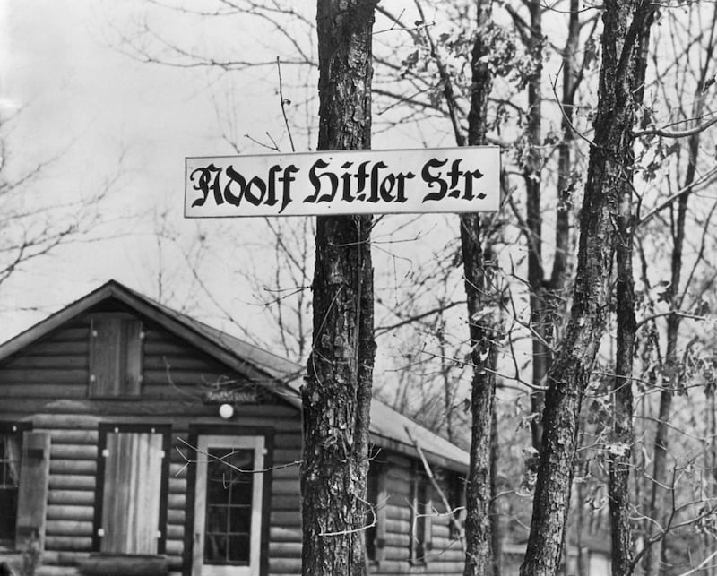 This view at a backwoods retreat looks as if it had been made in Germany's Black Forest or at some other Reich "Strength Through Joy" backwoods vacation spot, -- but guess again -- this "Adolf Hitler Strasse" is a street running through "Camp Siegfried" summer camp of the German American Bund at Yaphank, Long Island.