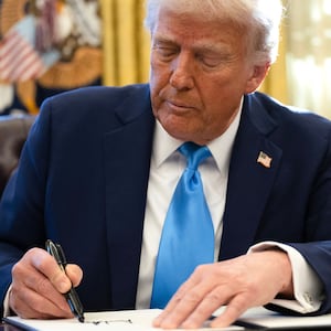 President Donald Trump signs an executive order withdrawing his country from a number of United Nations bodies in the Oval Office of the White House on February 4, 2025 in Washington, DC.