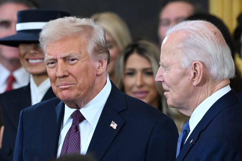Joe Biden (right) looks on Donald Trump arrives for his 2025 inauguration ceremony.